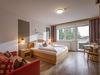 Comfort room with shower, toilet, flat screen TV and balcony